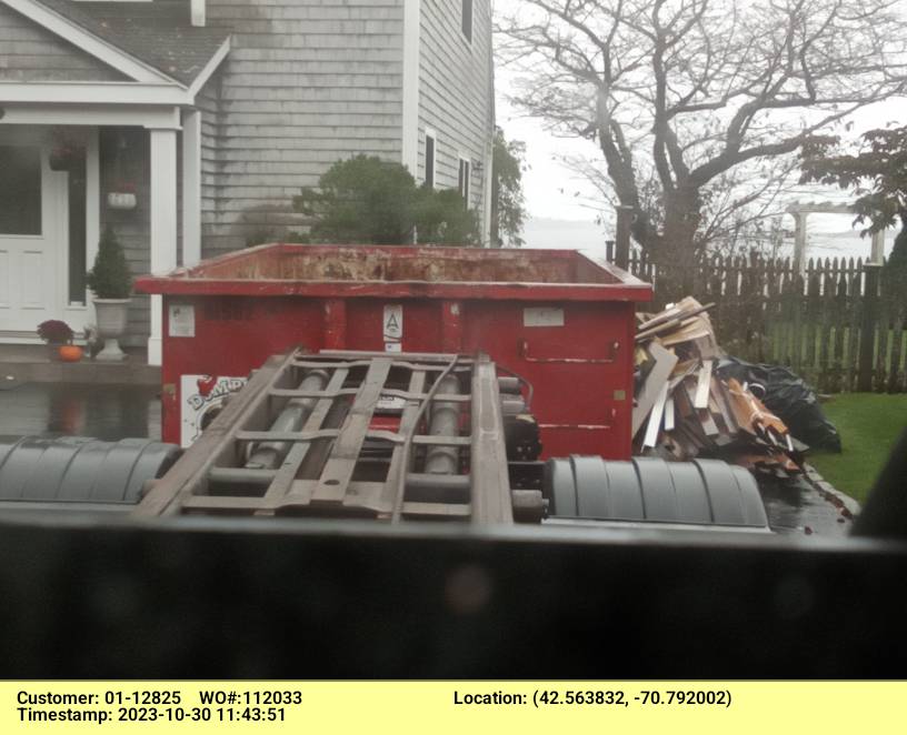 15 yard dumpster rental with a 2 ton weight limit delivered in Manchester, MA for a small roofing project.