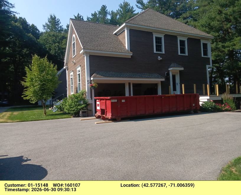 Dumpsters R Us roll-off truck placing a 20-yard container at a Middleton home in 01949