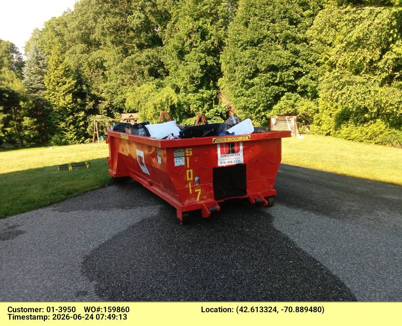10-yard roll-off dumpster from Dumpsters R Us, Inc. delivered to a construction site in Wenham, MA, with C&D debris visible inside.