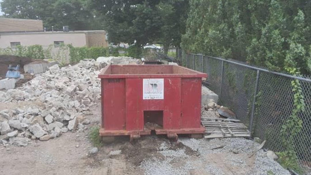 Dumpsters R Us, Inc. swapped a 15-yard ABC dumpster in Woburn, MA, for concrete debris from a residential project.