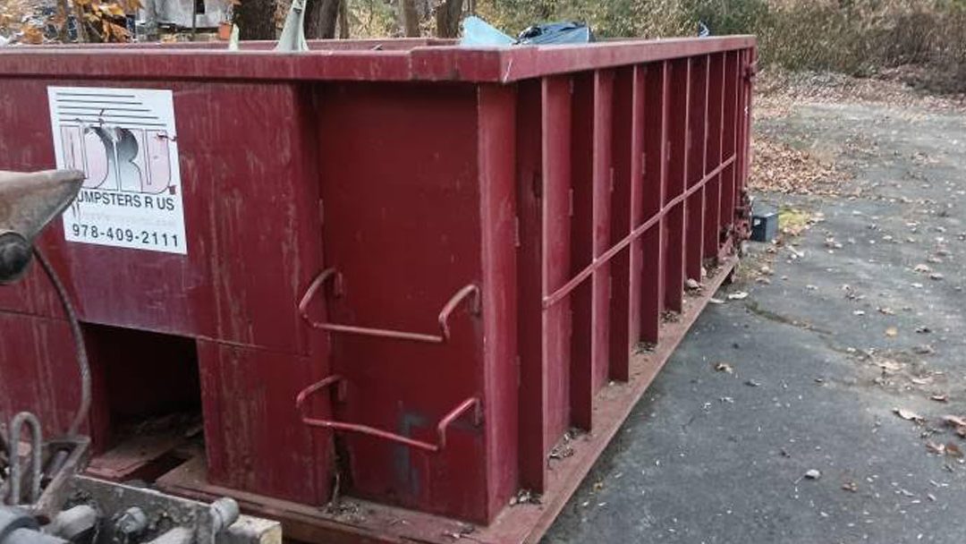 Dumpsters R Us 15 yard roll off dumpster loaded with residential remodel debris ready for pickup in Rowley MA